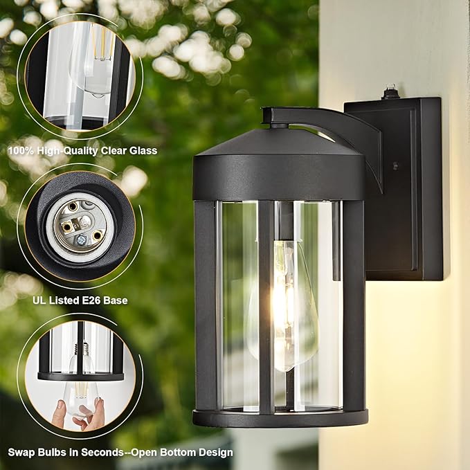 Outdoor wall light fixture with clear glass cover and bulb details on a blurred green background