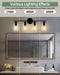 Black four-light bathroom light bar with clear glass covers