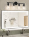 Black bar vanity light with four clear round shades