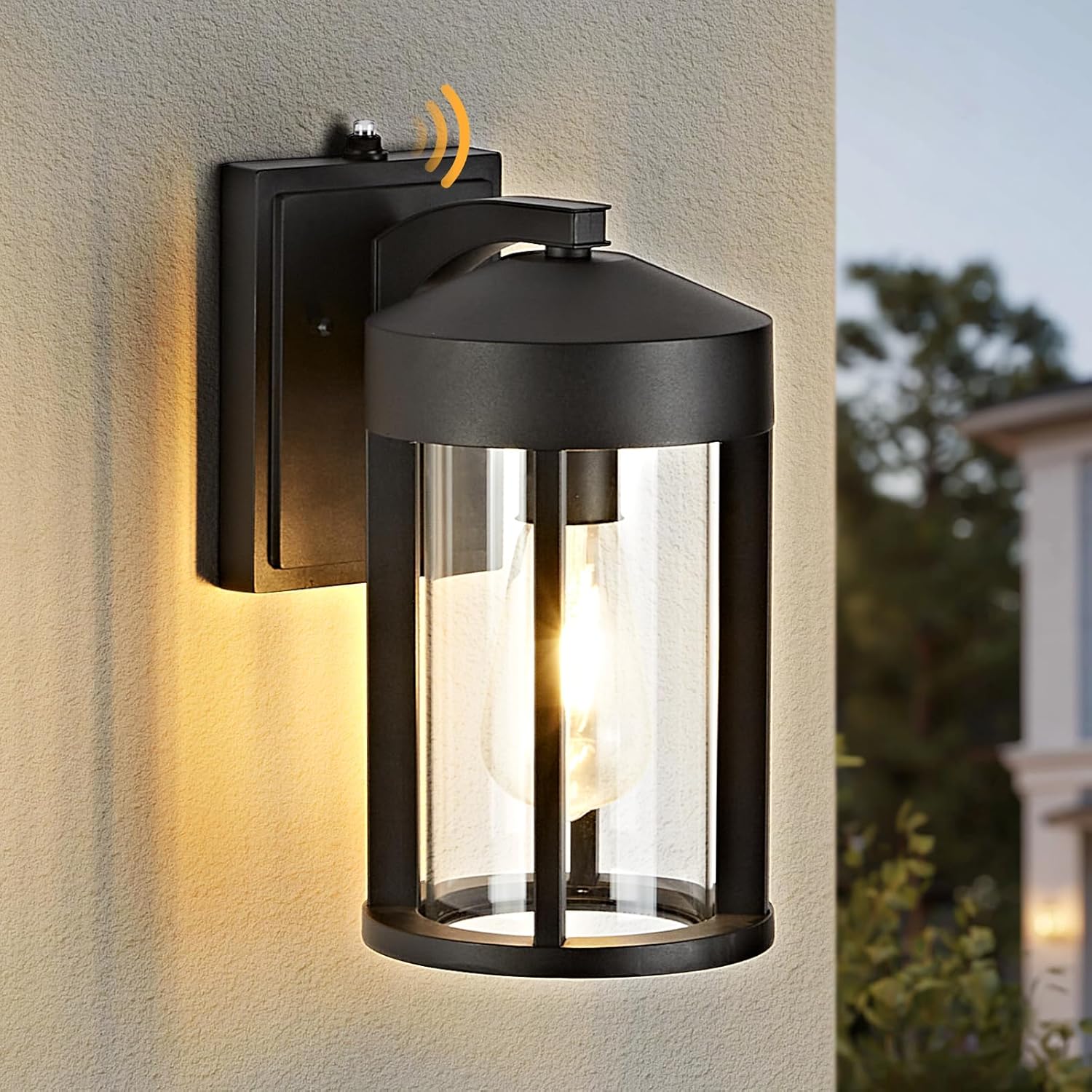 Black outdoor wall light fixture on a textured wall with a blurred background