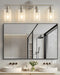 Transitional brushed nickel vanity light with rounded shades