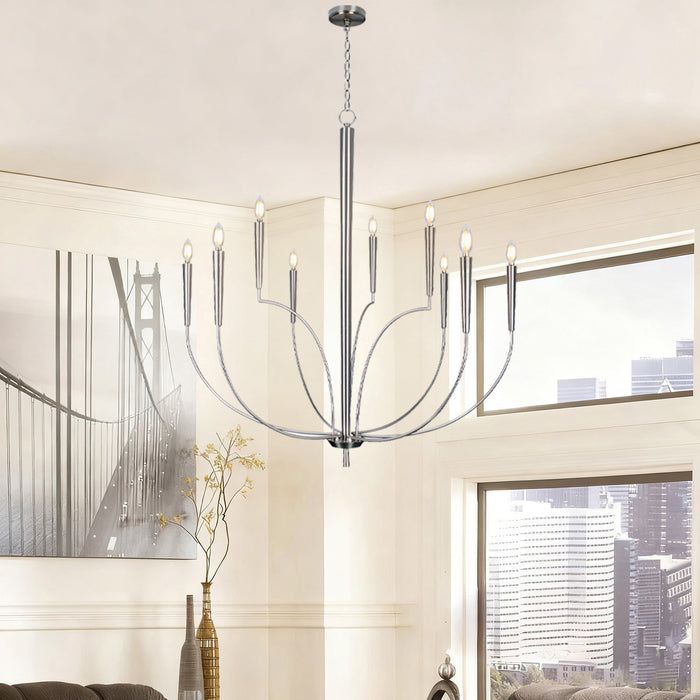 Modern chandelier hanging in a room with large windows and decorative elements.