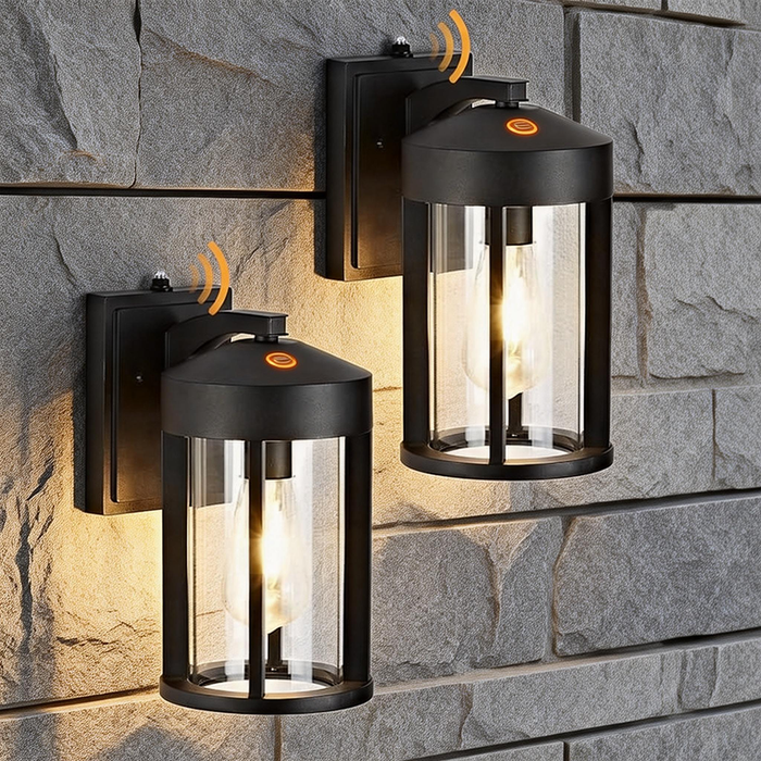 Two black outdoor wall lights mounted on a stone wall.